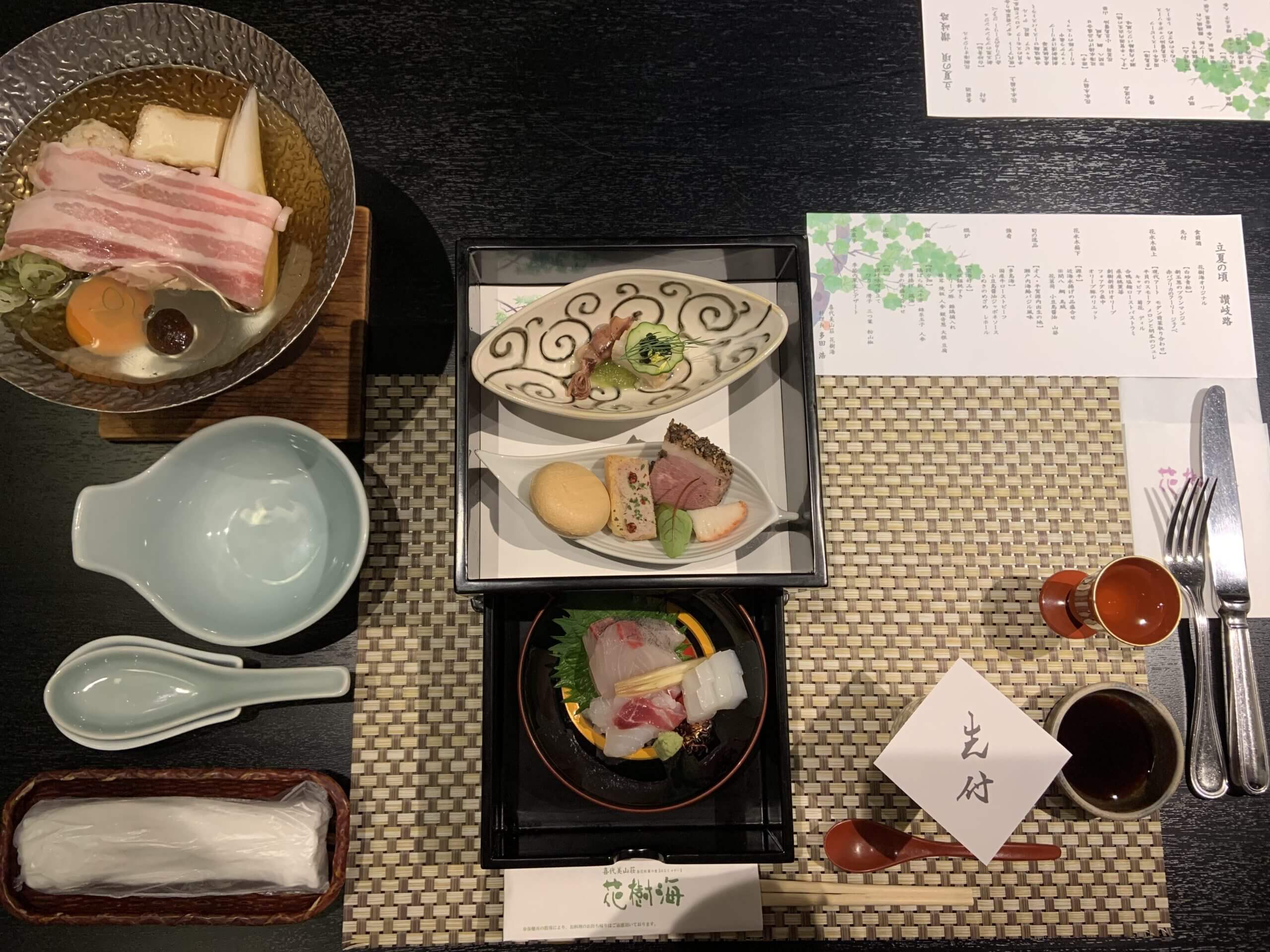 Traditional Japanese ryokan meal featuring seasonal local dishes