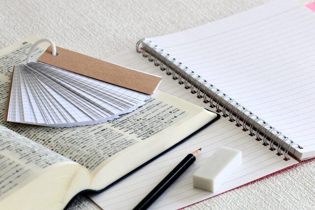 Japanese English textbook and vocabulary notebook on a desk