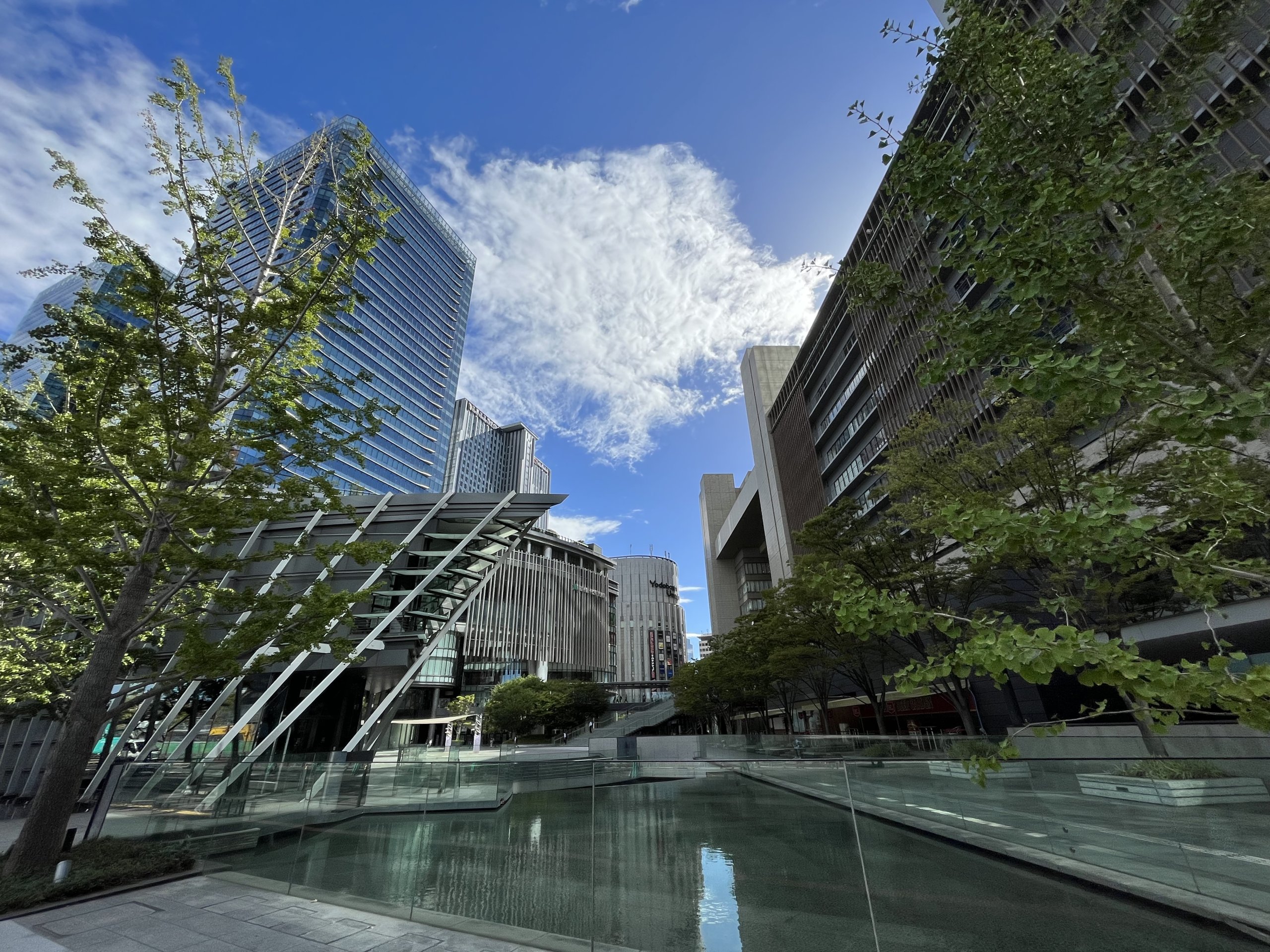 Busy Osaka Station area with large commercial buildings and complex walkways