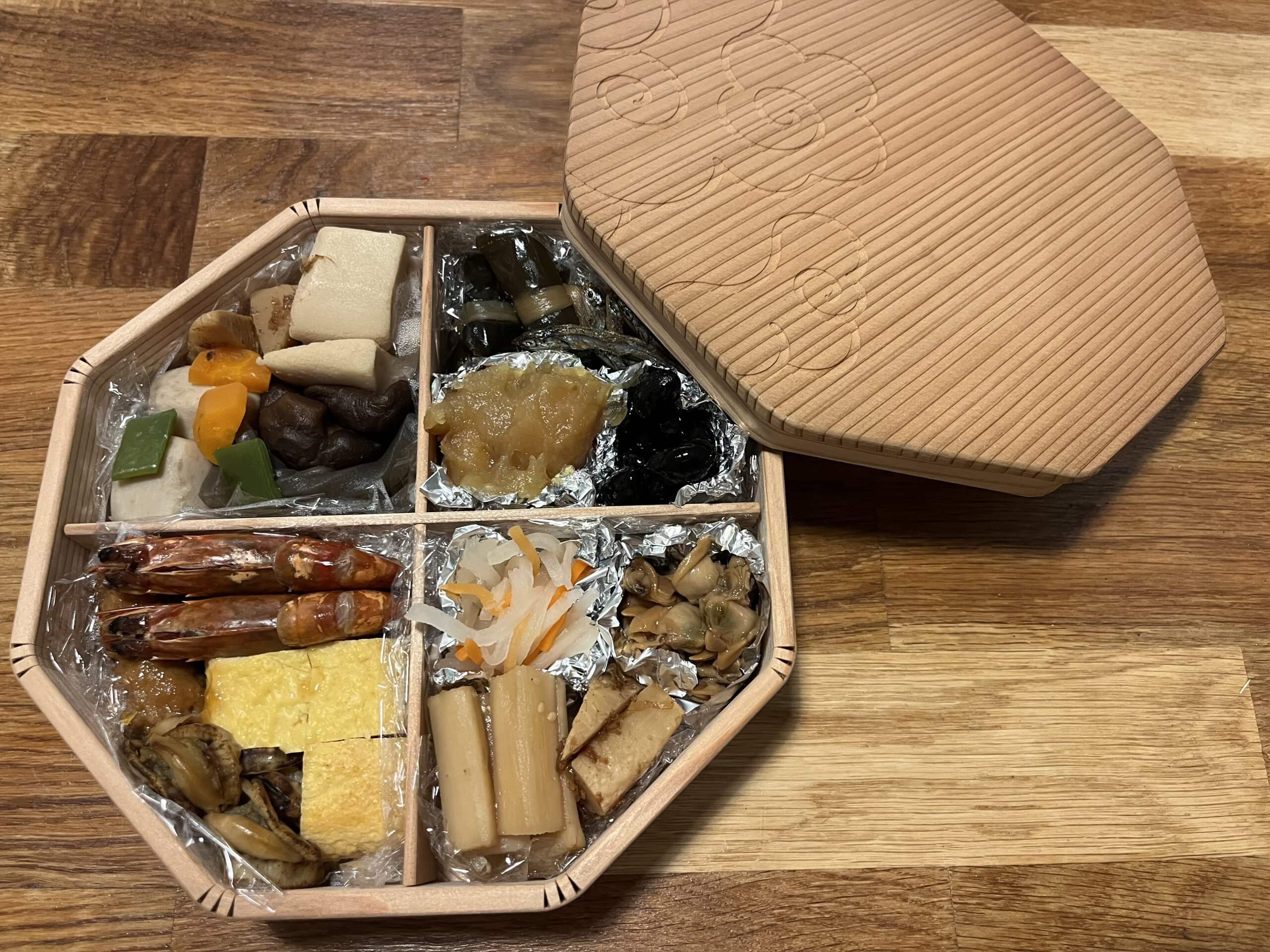 large octagonal wooden bento box filled with osechi for new year